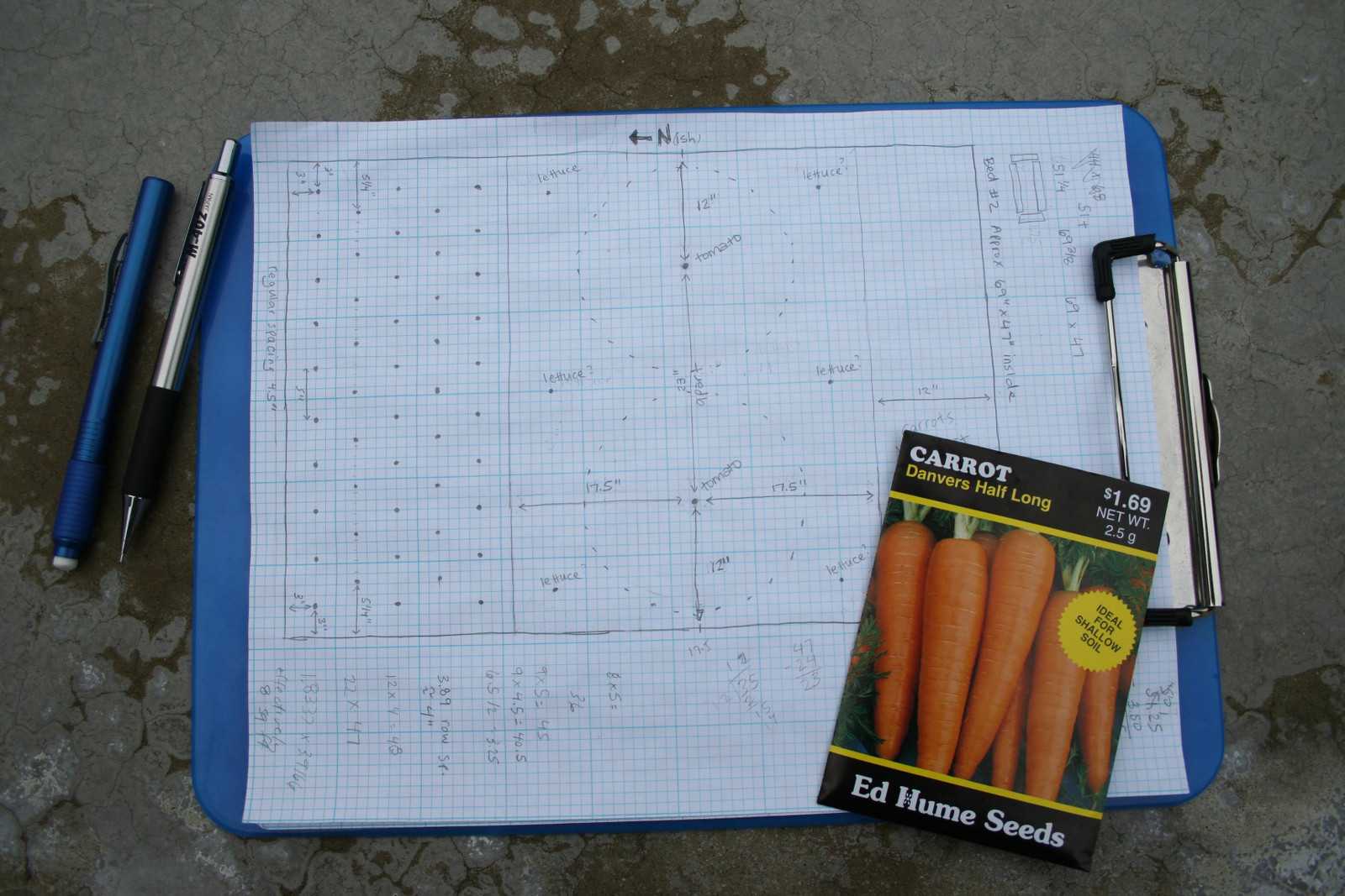 Layout for my second bed on graph paper with pencil, eraser, and carrot seed packet