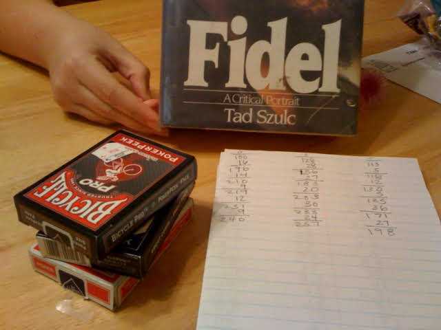 Cards and Scorepad for Nertz with a Book that says 'Fidel', D: 240, S: 257, T: 198