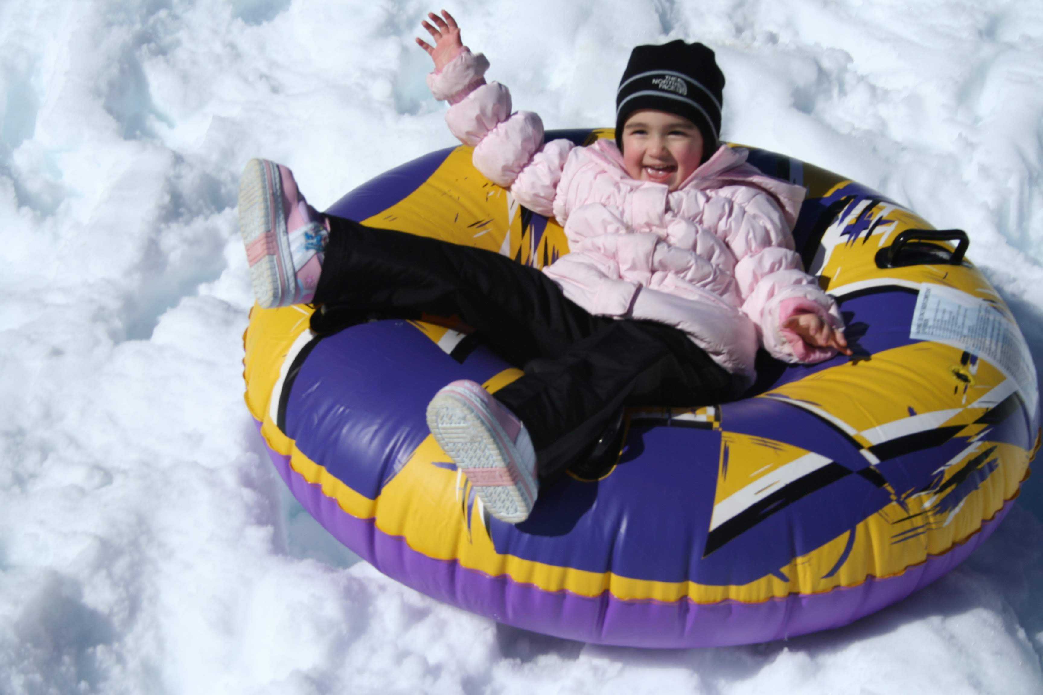 Allie tubing down the hill